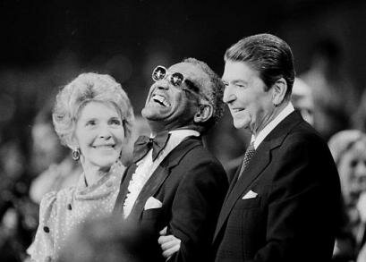 Music legend Ray Charles, center, laughs as President Reagan and Nancy Reagan joined him at a salute to country music at Constitution Hall in Washington, D.C., on March 16, 1983. Charles died Thursday, June 10, 2004, a spokesman said. He was 73. (AP Photo/Ira Schwarz)